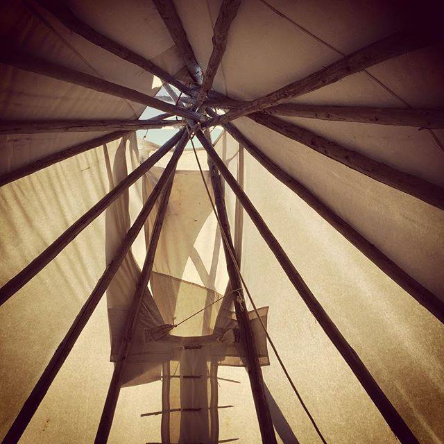 Looking up at the roof of a tipi 