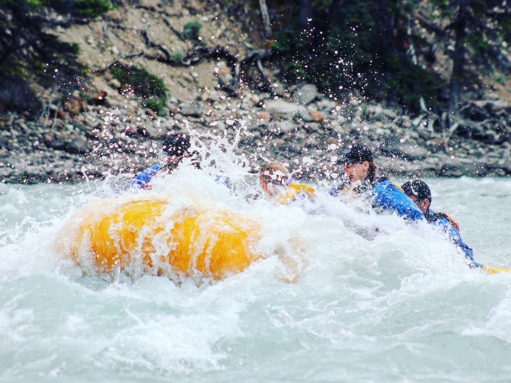 white water rafting through a rapid