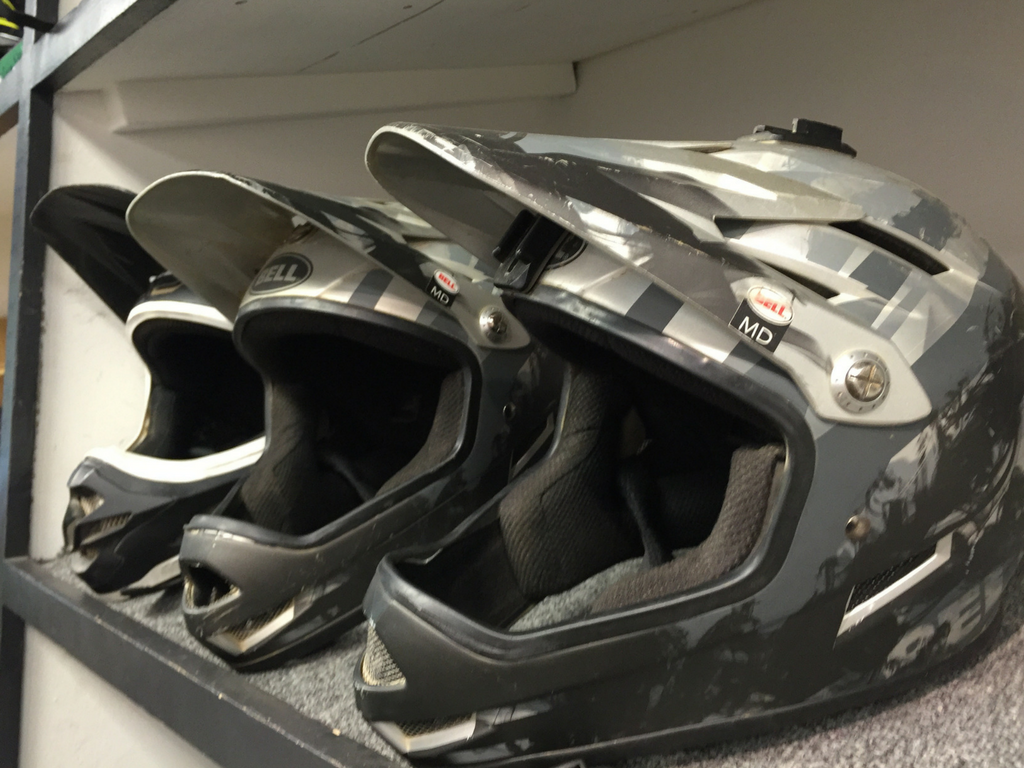 helmets lined up on a shelf