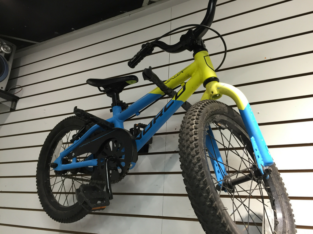 kids mountain bike hanging on the wall in store