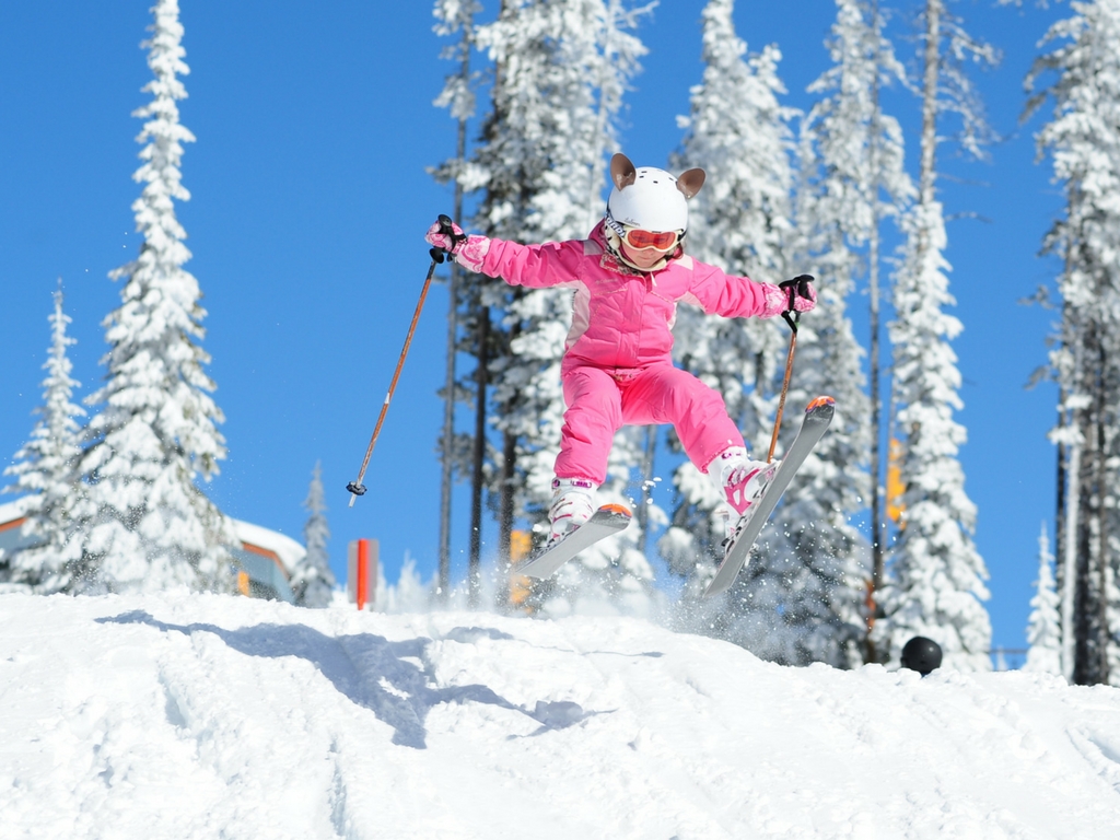 young girl skiing at Big White Resort, one of the best family ski resorts in BC