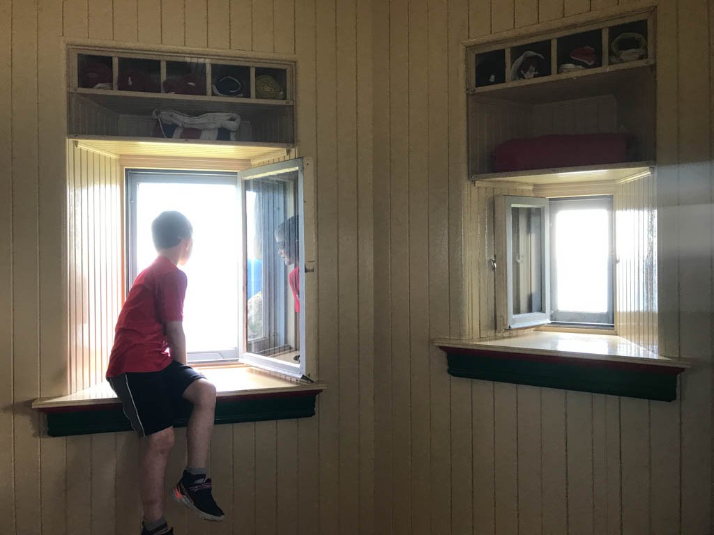 Boy looking out window of castle at Signal Hill National Historic Site