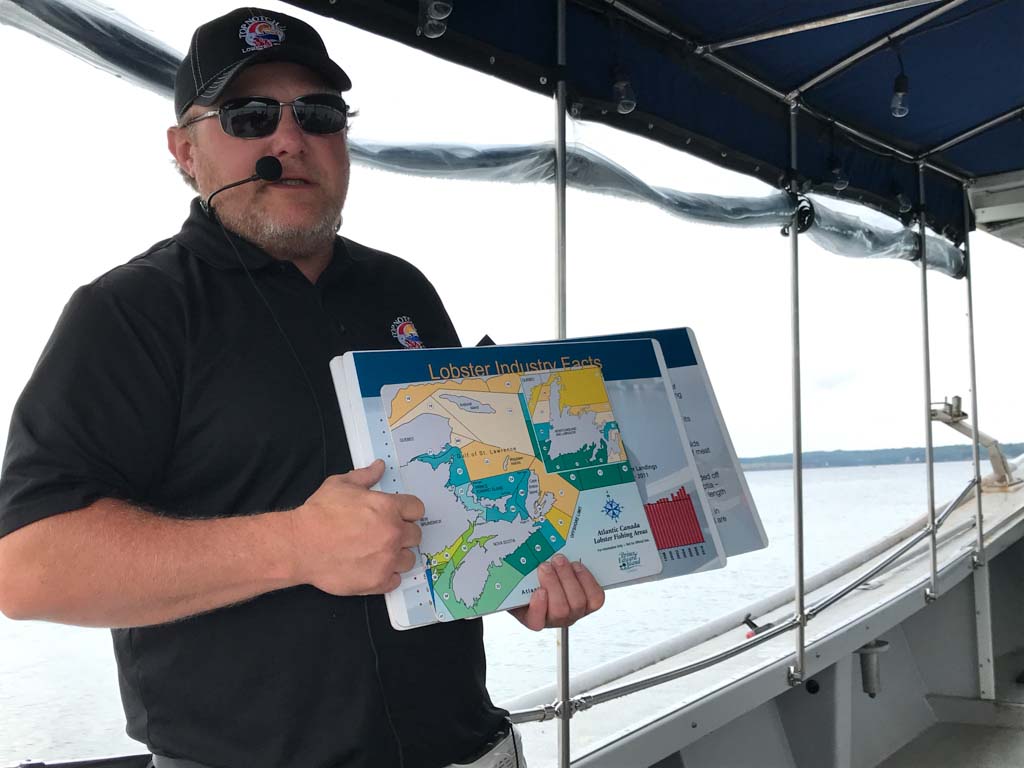 Top Notch Charters boat captain holding up a map