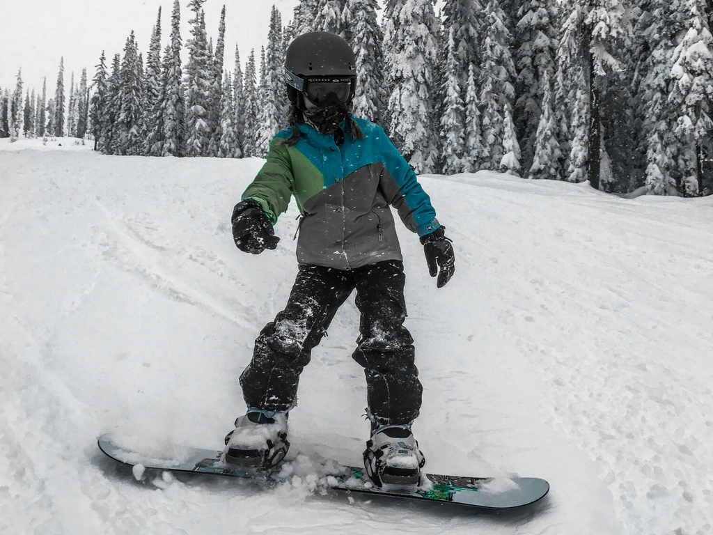 Girl snowboarding on a Big White family ski trip