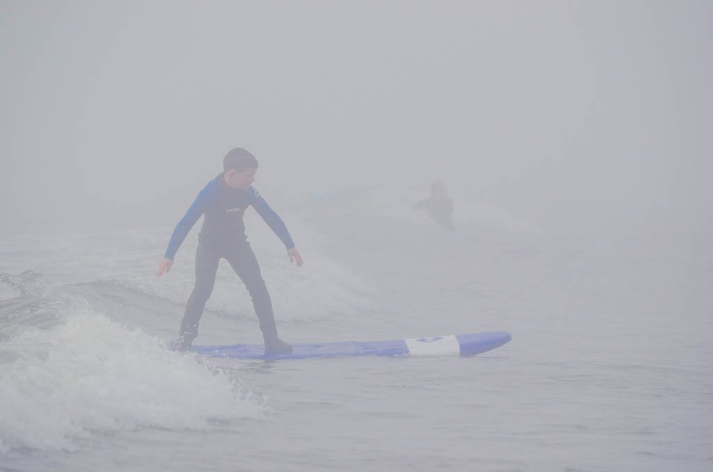 Boy surfing in Tofino