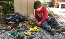 kid-playing-outside-with-cars