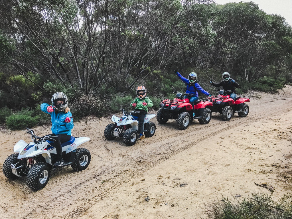 family posing for a photo while sitting on quads