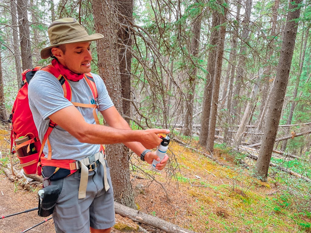 hiking guide demonstrating how to use bear spray